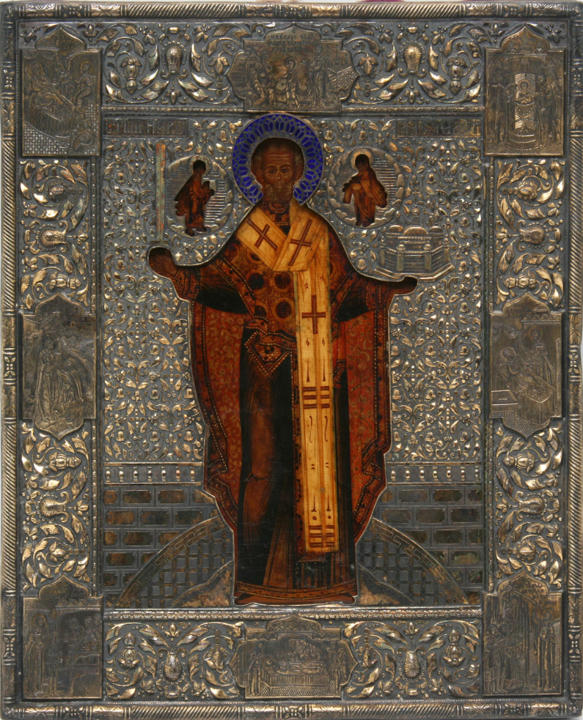 Оклад для иконы Николая Можайского. Вторая половина XIX века. Серебро, золочение, чернь, гравировка в торцах и углах сцен жития святого, чеканка в технике высокого орнамента «гречкой», выемчатая эмаль. 